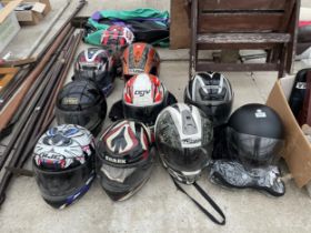 A LARGE QUANTITY OF MOTORBIKE HELMETS AND A SET OF LEATHERS