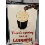 A LARGE METAL GUINNESS SIGN