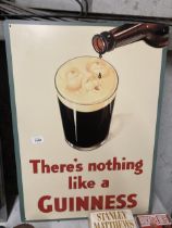A LARGE METAL GUINNESS SIGN