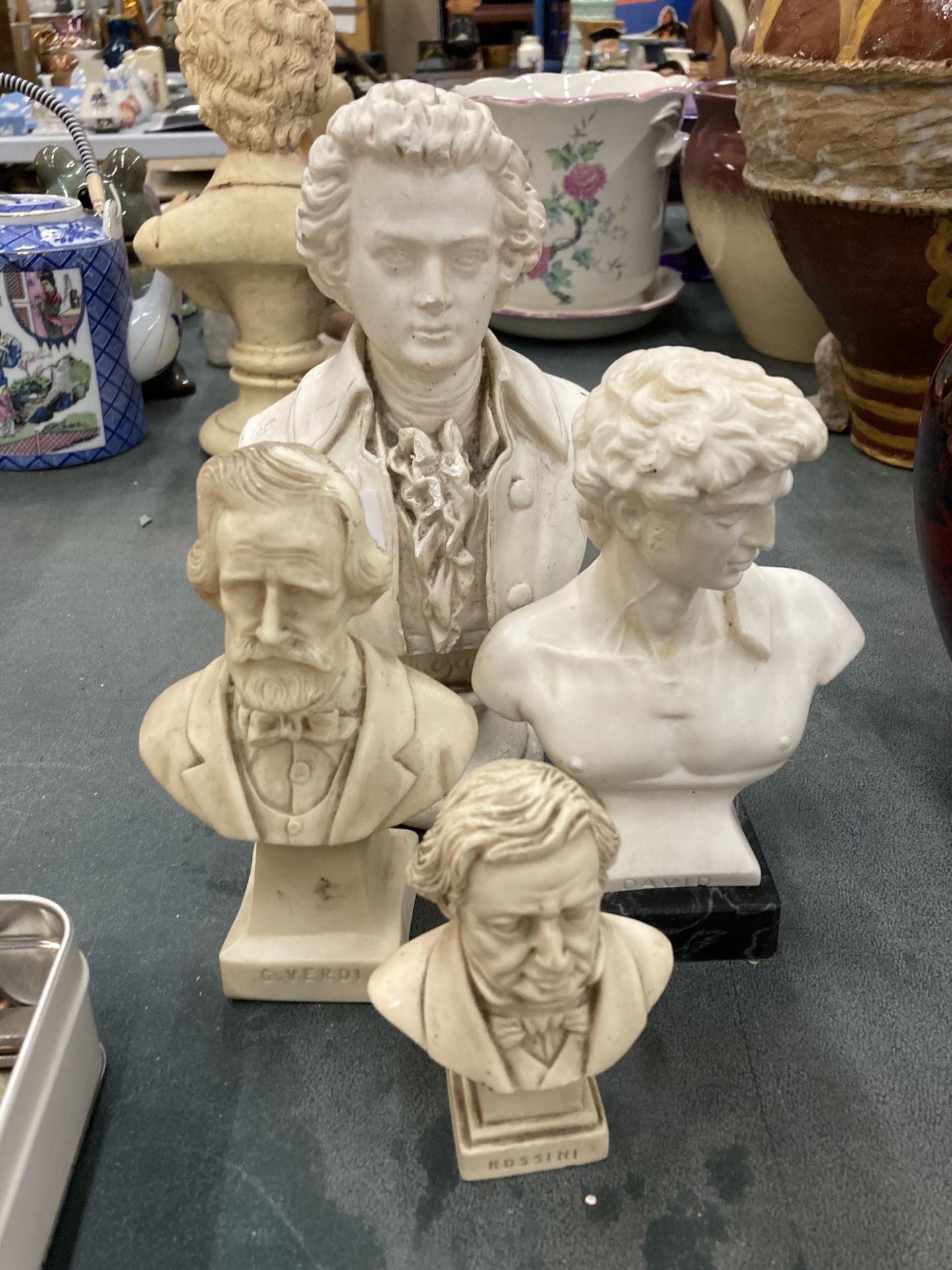 A GROUP OF FOUR RESIN BUSTS OF CLASSICAL FIGURES