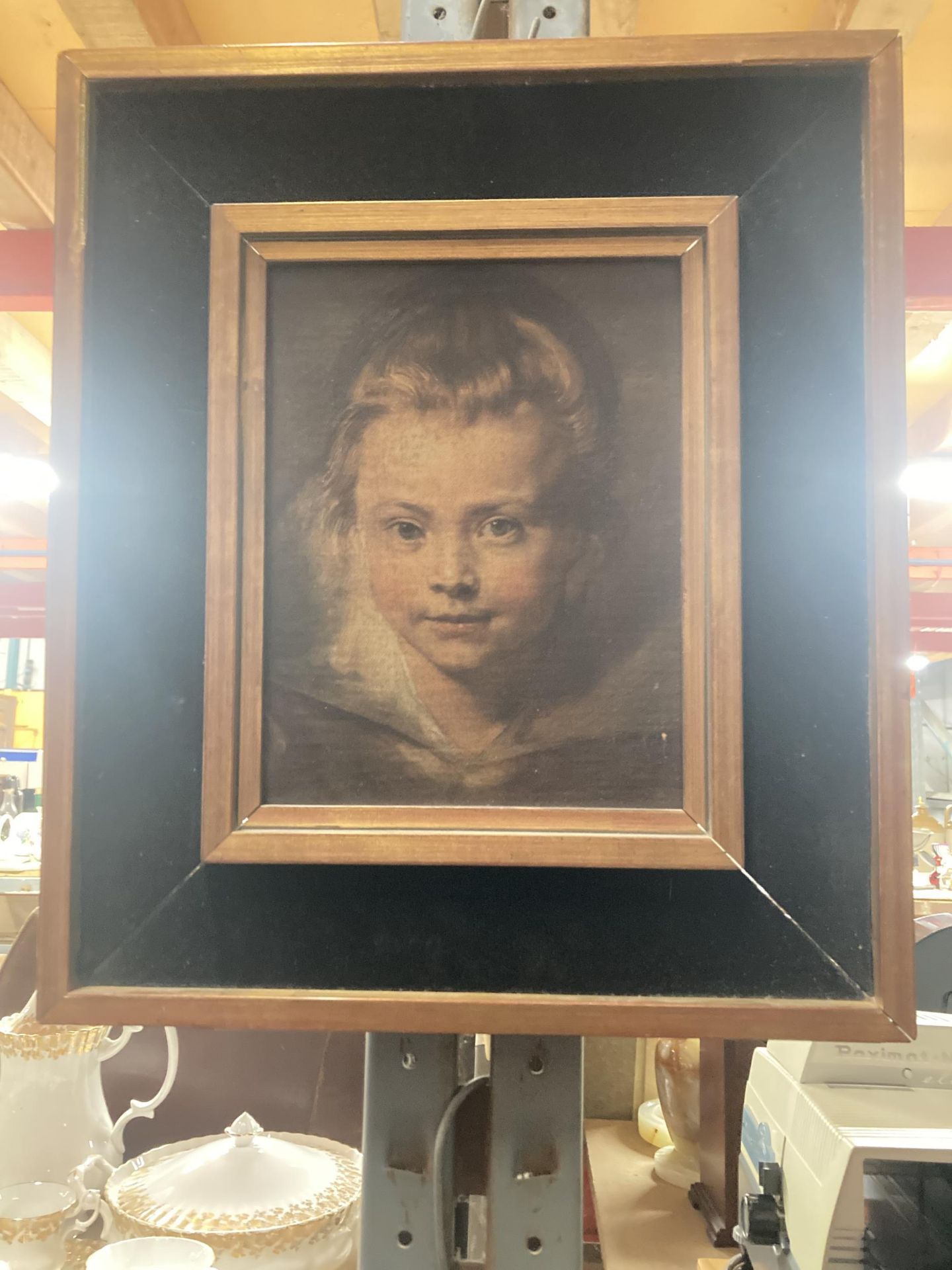 A WOODEN FRAMED OLEOGRAPH PRINT OF A YOUNG GIRL