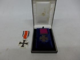 A CASED REPLICA VICTORIA CROSS AND A REPLICA IRON CROSS