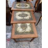 A NEST OF THREE RETRO TEAK TILED TOP TABLES, MADE IN DENMARK, BY MOBELFABRIKKEN TOFTEN