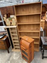 A PINE EFFECT SIZ TIER OPEN BOOKCASE, C.D RACK AND SMALL PINE UNIT WITH ROLL TOP