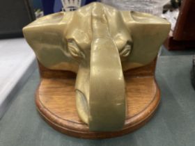 A HEAVY BRASS ELEPHANTS HEAD WALL SCONCE