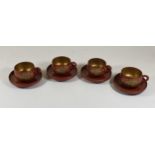 A SET OF CHINESE RED LACQUERED AND GILT DESIGN TEACUPS AND SAUCERS, SAUCER DIAMETER 9 CM
