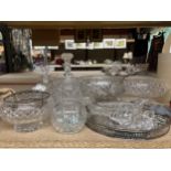 A QUANTITY OF GLASSWARE TO INCLUDE DECANTERS, BOWLS, A ROUND GALLERIED TRAY, VASES, ETC