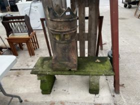 A CONCRETE GARDEN BENCH AND A CHIMNEY POT