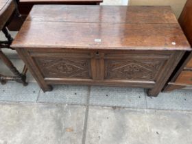 A GEORGE III OAK BLANKET CHEST WITH CARVED FRONT PANELS, 44" WIDE