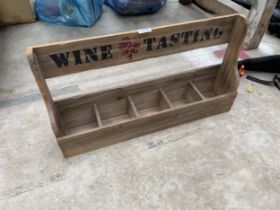 A WOODEN MONOGRAMED WINE TASTING RACK