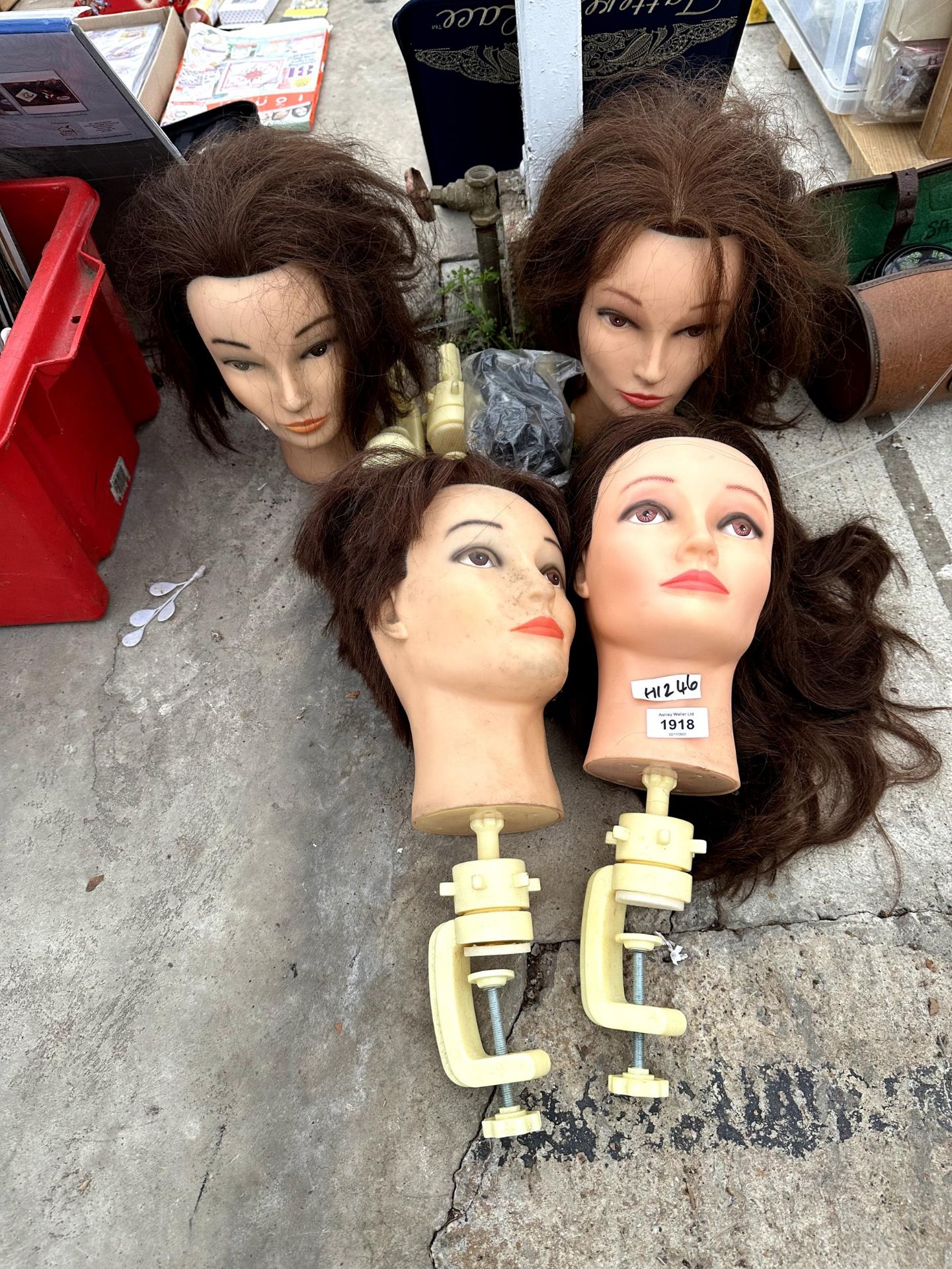 FOUR MANEQUIN HEADS WITH CLAMP BASES