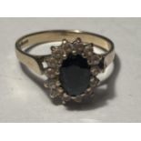 A 9 CARAT GOLD RING WITH CENTRE SAPPHIRE SURROUNDED BY CUBIC ZIRCONIAS SIZE N