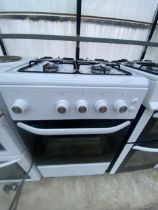 A BLACK AND WHITE GAS OVEN AND HOB