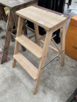 A SMALL WOODEN TWO RUNG STEP SEAT