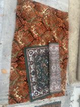 A GREEN PATTERNED RUG AND AN ORANGE PATTERNED RUG