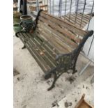 A WOODEN SLATTED GARDEN BENCH WITH CAST BENCH ENDS