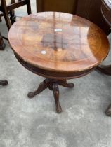 A 21" DIAMETER WALNUT AND CROSSBANDED PEDESTAL TABLE