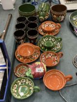 A COLLECTION OF POTTERY DECORATED IN A 'BARGE ART' STYLE TO INCLUDE A PIGGY BANK, PLANTERS, CUPS,