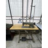 A BROTHER INDUSTRIAL SEWING MACHINE WITH TREADLE BASE AND ANGLE POISE LAMP