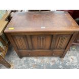 AN OAK JACOBEAN STYLE BLANKET CHEST WITH LINEN FOLD FRONT PANELS AND SINGLE DRAWER, 31" WIDE