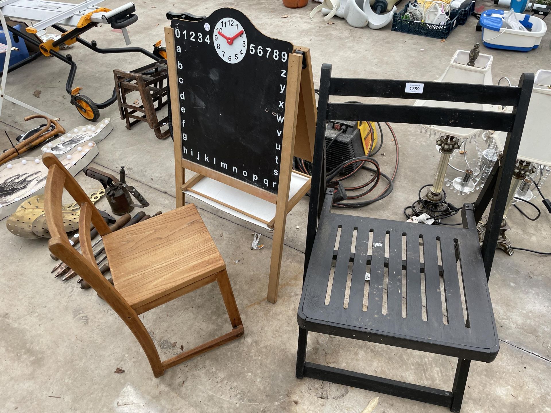 A FOLDING WOODEN CHAIR, A CHILDS CHALK BOARD AND A CHILDS CHAIRS