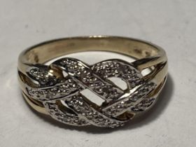 A 9 CARAT GOLD RING WITH DIAMONDS IN A CROSSOVER DESIGN SIZE M