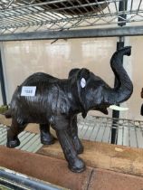 A MINIATURE DECORATIVE LEATHER BOUND ELEPHANT