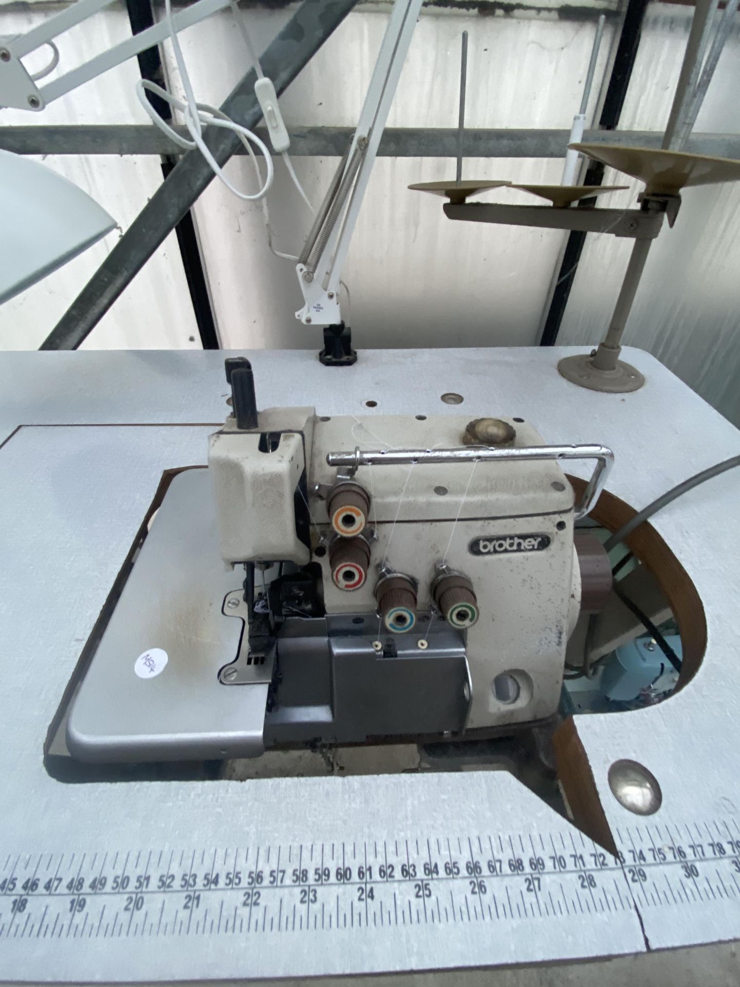 A BROTHER INDUSTRIAL OVERLOCKER SEWING MACHINE WITH TREADLE BASE AND ANGLE POISE LAMP - Image 2 of 3
