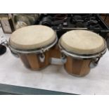 A PAIR OF WOODEN BONGO DRUMS