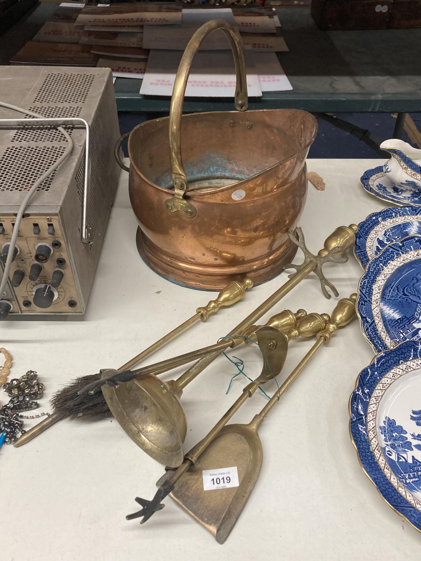 A COPPER COAL SCUTTLE WITH BRASS HANDLE PLUS A BRASS COMPANION SET