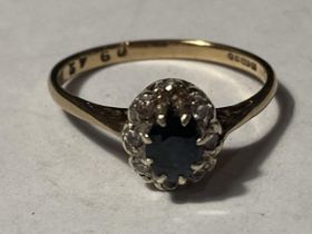 A 9 CARAT GOLD RING WITH CENTRE SAPPHIRE SURROUNDED BY DIAMONDS SIZE K/L