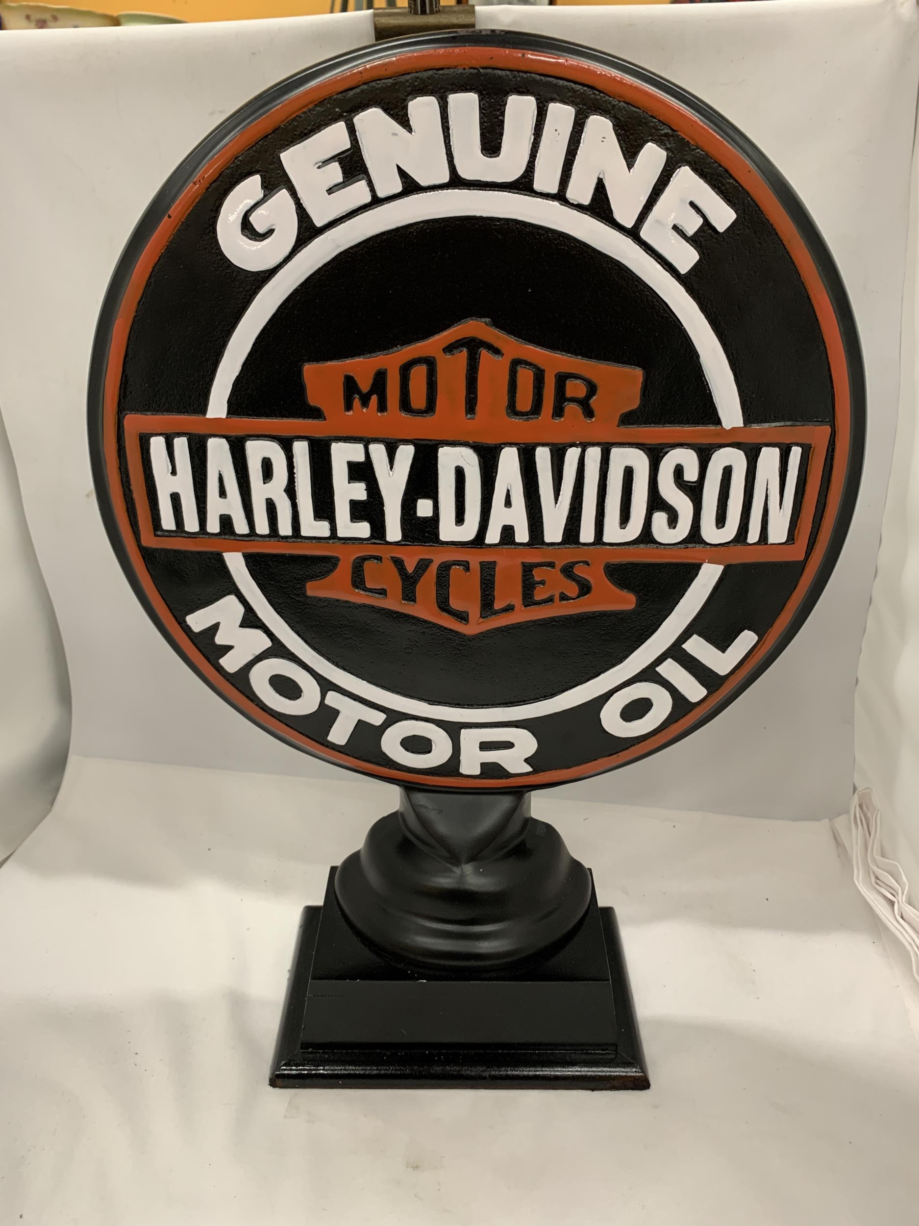 A LARGE CONVEX STEEL HARLEY DAVIDSON MOTOR OIL SIGN ON PEDESTAL, 21" HIGH