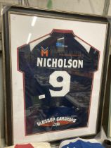 A FRAMED AND GLAZED SPORTS TOP, POSSIBLY SWINTON LIONS RUGBY, A/F TO THE GLASS, WITH NICHOLSON NAME