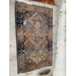 A SMALL PATTERNED FRINGE RUG