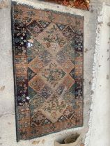 A SMALL PATTERNED FRINGE RUG