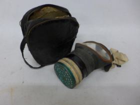 A WORLD WAR II GAS MASK AND BAG