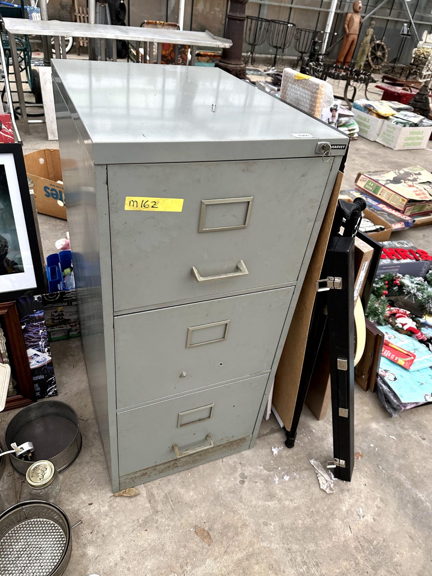 A THREE DRAWER METAL FILING CABINET