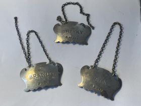 THREE HALLAMRKED SHEFFIELD SILVER DECANTER LABELS BRANDY, WHISKY AND GIN GROSS WEIGHT 44.5 GRAMS