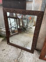 AN OAK WALL MIRROR WITH FOLIATE CARVING, 33 X 27"