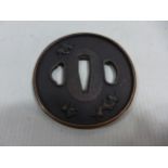 A JAPANESE BRONZE TSUBA DECORATED WITH MYTHICAL BEASTS, DIAMETER 8CM