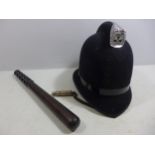 A WORLD WAR I WHISTLE DATED 1915, HARDWOOD POLICE TRUNCHEON, LENGTH 38CM AND A POLICE HELMET (3)