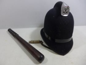 A WORLD WAR I WHISTLE DATED 1915, HARDWOOD POLICE TRUNCHEON, LENGTH 38CM AND A POLICE HELMET (3)