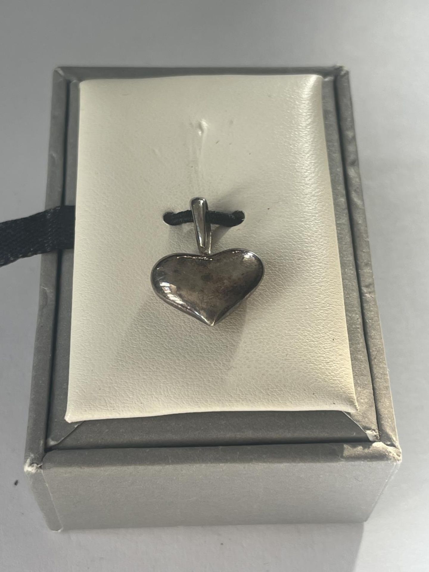 A BOXED SILVER HEART
