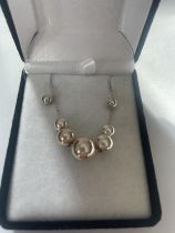 A BOXED SILVER NECKLACE SET