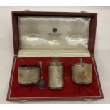 A CASED BIRMINGHAM HALLMARKED SILVER THREE PIECE CONDIMENT SET COMPRISING PEPPERETTE, OPEN SALT