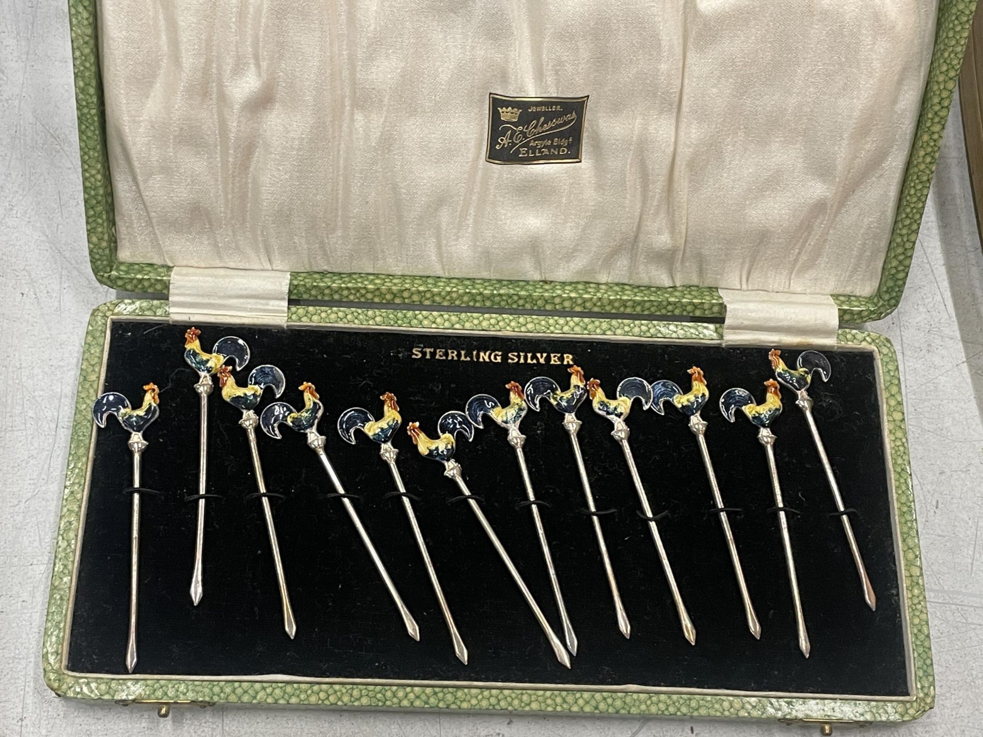 A CASED SET OF STERLING SILVER AND ENAMEL COCKEREL COCKTAIL STICKS