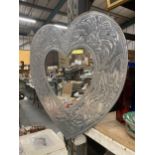 AN ORNATE METAL HEART SHAPED MIRROR