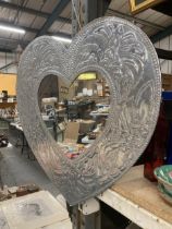 AN ORNATE METAL HEART SHAPED MIRROR