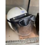 A MOTORBIKE HELMET AND A PAIR OF GOGGLES