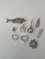 A BAG OF SILVER PENDANTS